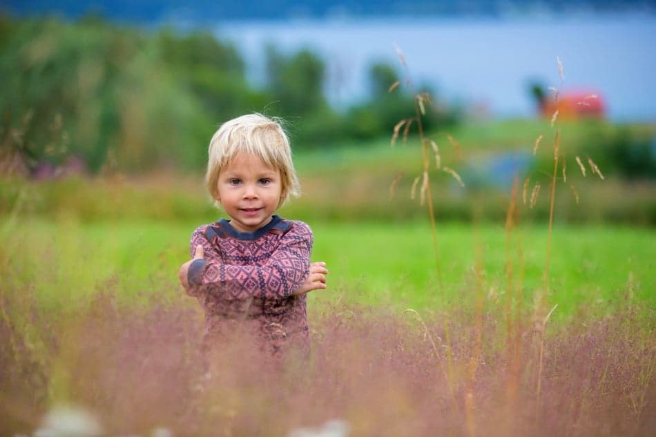 Little boy standing on a field
